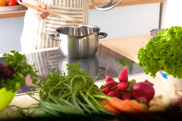 Young Woman Cooking in the kitchen. Healthy Food