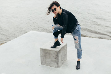 Stylish model posing at the urban lake.