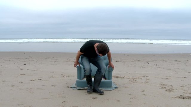 Person walks up and sits on a, not-so-typical beach chair at the Oregon Coast.