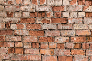 Fragment of old brick wall made of red brick.
