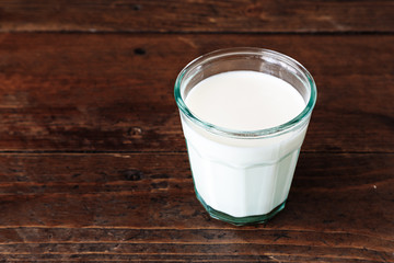 glass of milk on a wooden background