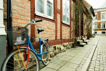 Fototapeta na wymiar Colorful bike standing against a wall of an old half timberd house