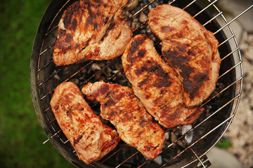 Tasty steaks on barbecue grill, close up view