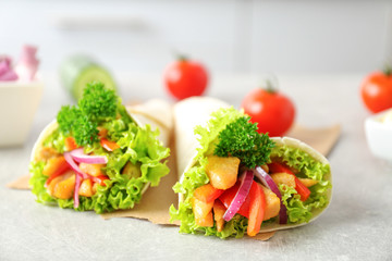 Delicious kebab sandwiches on kitchen table