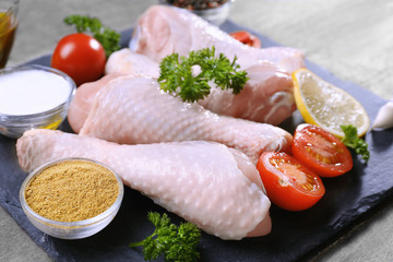 Raw chicken legs with spices, closeup