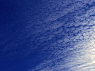 Blue sky with big amount of  white clouds blurred background