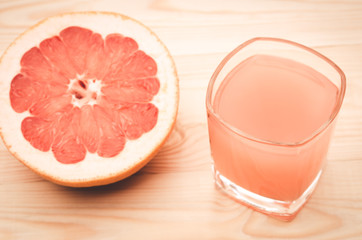 juice and grapefruit on a wooden table/grapefruit juice with fruit on a table