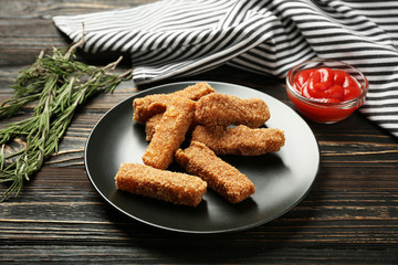Tasty cheese sticks with rosemary and ketchup on table