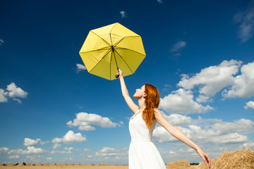 photo of beautiful young woman with umbrella on the wonderful sky background