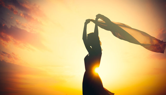 photo of beautiful young woman with shawl on the wonderful sunset background