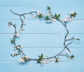 Flower frame on a blue wooden background