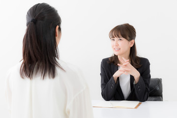 asian businesswomen talking in office