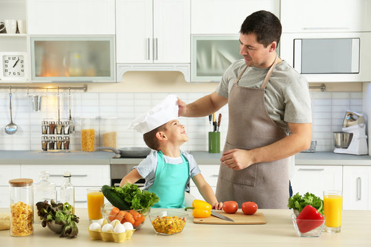 Father and son cooking together in kitchen