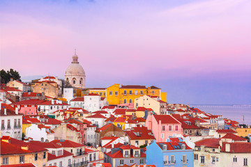 View of Alfama, the oldest district of the Old Town, from belvedere Miradouro das Portas do Sol at scenic sunset, Lisbon, Portugal © Kavalenkava
