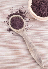 Acai powder on wooden spoon (Euterpe oleracea)