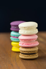 Tasty macaroons with almond on wooden background