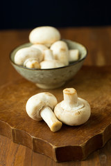 Champignon mushrooms on the wooden table. Selective focus