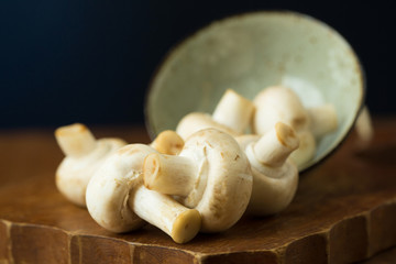 Champignon mushrooms on the wooden table. Selective focus