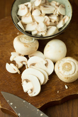 Champignon mushrooms on the wooden table. Selective focus