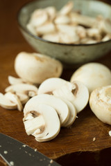 Champignon mushrooms on the wooden table. Selective focus