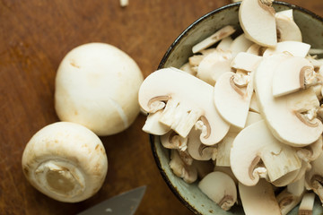 Champignon mushrooms on the wooden table. Selective focus