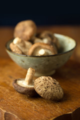 Shiitake mushrooms on a wooden table. Selective focus