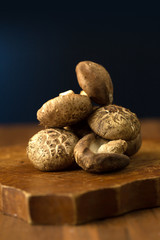Shiitake mushrooms on a wooden table. Selective focus