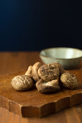 Shiitake mushrooms on a wooden table. Selective focus