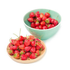 Fresh ripe strawberries in small wooden bowl on white background.
