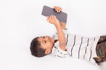 Cute little asian boy lying play tablet on floor © napatcha
