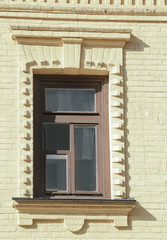 Fototapeta na wymiar Wooden window with brick yellow wall