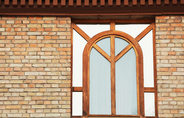Wooden window with toned glass and brick wall background