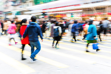 crowd of people crossing a city street