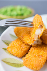 breaded fish fingers with peas