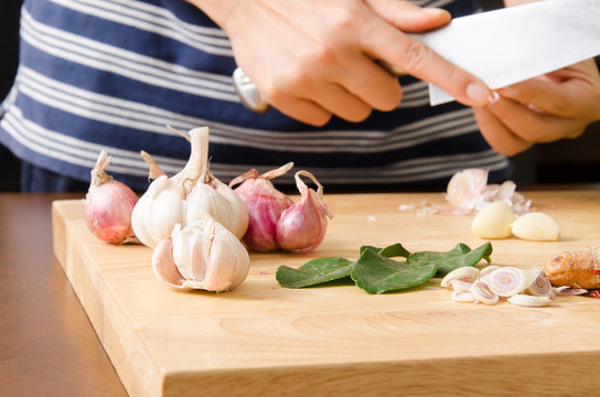 Chef peeling garlic by knife for cooking Thai food