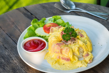 Omelet with bacon and rice on plate