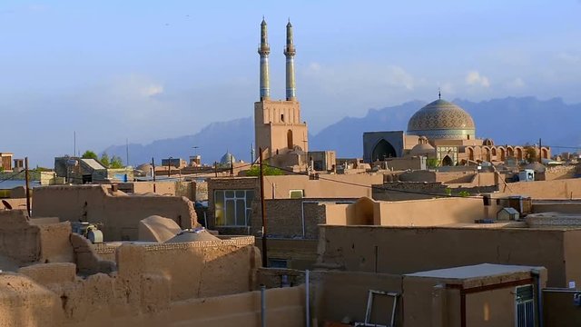 Panorama of a historical part of the city of Yazd, old clay constructions, over the city tower minarets