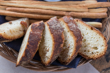 Freshly baked sliced bread on rustic wooden table, close up of brown bread.