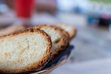 Freshly baked sliced bread on rustic wooden table, close up of brown bread.