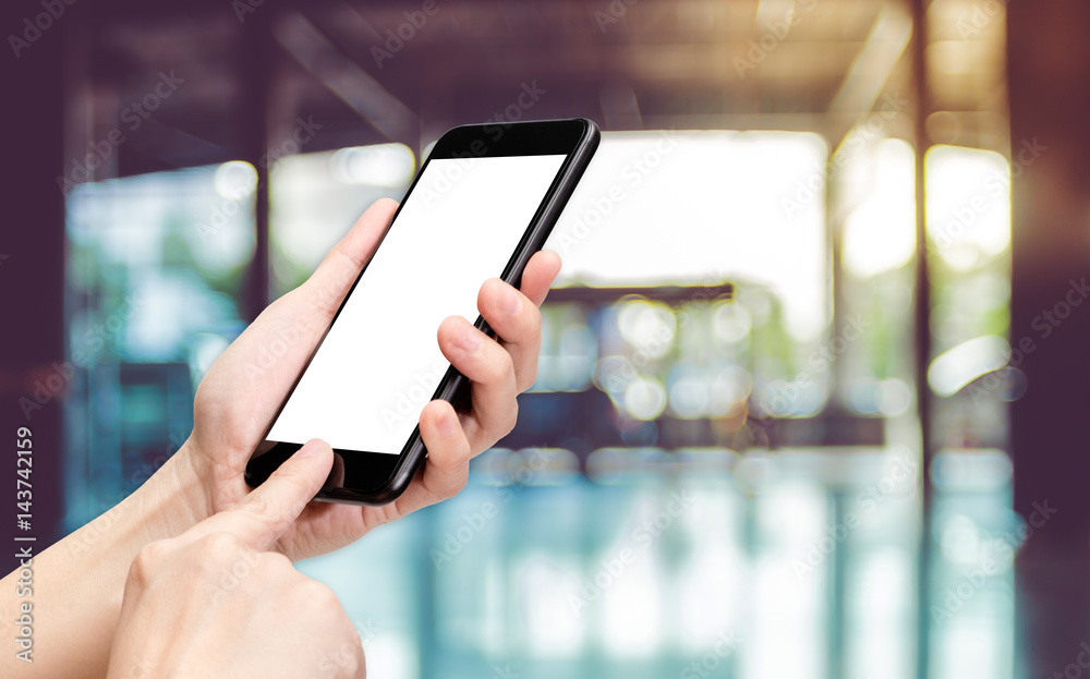Poster Hand click mobile phone with blur office corridor hall way background bokeh light,White screen mock up template for adding your design or your text