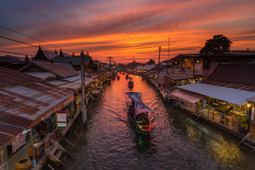 Sunset and Boat on canal with old market, this lace is call Ampawa floating market, SamuthsongkramThailand