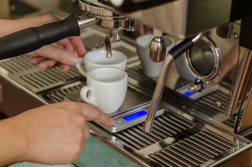 Cropped Hand Of Worker Pouring Coffee Into Cups At Cafe