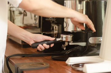 Cropped Hand Of Worker Pouring Coffee Into Cups At Cafe