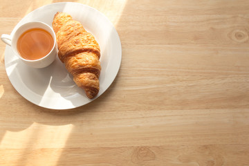 croissant and tea for breakfast with copy space