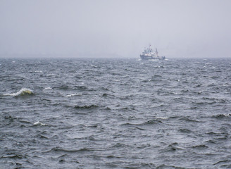 boat on the river and waves during a storm