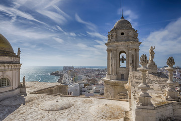 This bell tower and statues in the roof of the Cathedral of Cadiz, completed in the nineteenth century is located very close to the sea, take in Cadiz, Andalusia, Spain Western Europe © digicomphoto