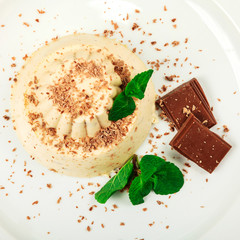 Blancmange with chocolate on glass plate
