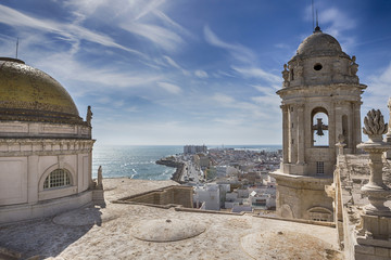 This bell tower and statues in the roof of the Cathedral of Cadiz, completed in the nineteenth century is located very close to the sea, take in Cadiz, Andalusia, Spain Western Europe © digicomphoto