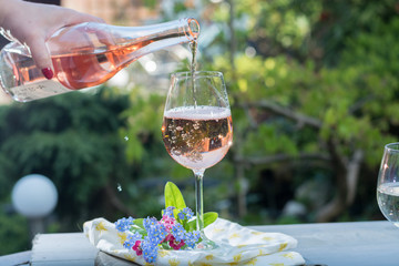 Waiter pouring a glas of cold rose wine, outdoor terrase, sunny day © barmalini