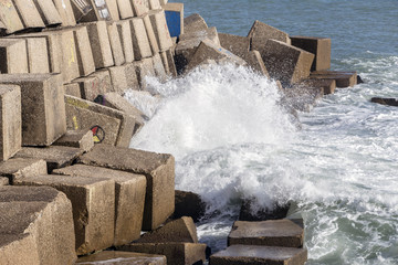 Waves hit the rocks on the promenade of the La Caleta beach in Cadiz, Spain